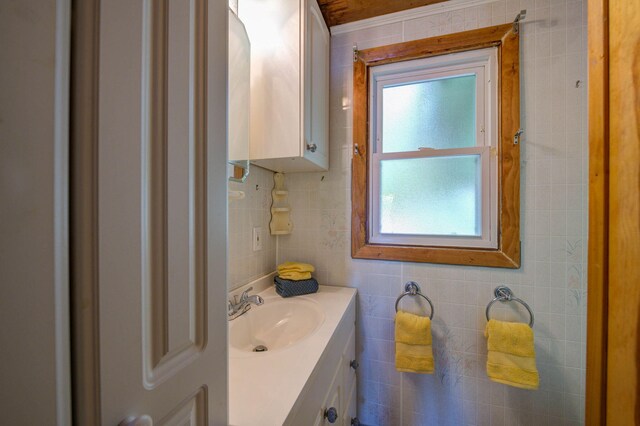 19 Pulpit Rock Rd, Raymond, ME 04071 - bathroom with vanity and tile walls