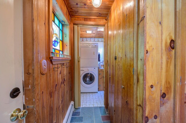 19 Pulpit Rock Rd, Raymond, ME 04071 - laundry room featuring estacked washer and dryer, wood walls, wood ceiling, and baseboard heating