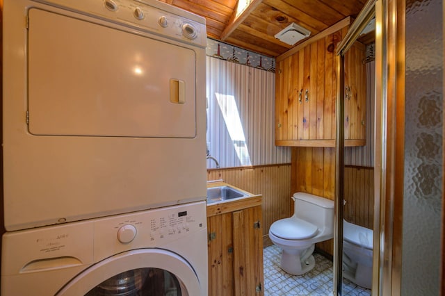 19 Pulpit Rock Rd, Raymond, ME 04071 - laundry area with stacked washer / drying machine, wood ceiling, wooden walls, and a wainscoted wall