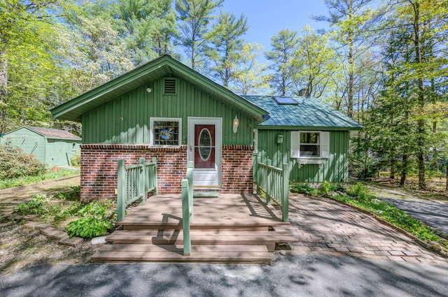 19 Pulpit Rock Rd, Raymond, ME 04071 - view of front of property with board and batten siding and brick siding