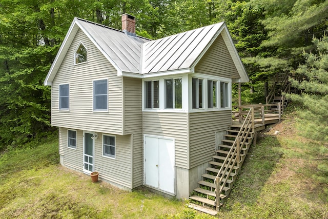 67 Day Mountain Rd, Temple, ME 04984 - rear view of property featuring a standing seam roof, stairs, a chimney, a wooden deck, and a metal roof