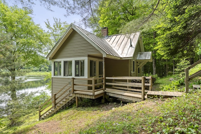 67 Day Mountain Rd, Temple, ME 04984 - rear view of property with a chimney, a standing seam roof, a deck with water view, stairway, and a metal roof