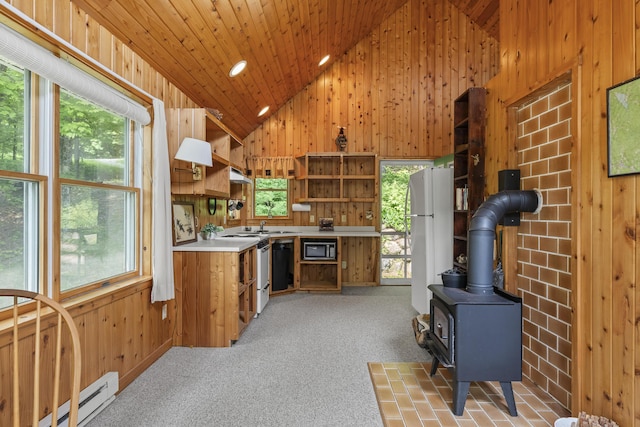 67 Day Mountain Rd, Temple, ME 04984 - kitchen with open shelves, built in microwave, wood walls, a baseboard radiator, and light countertops