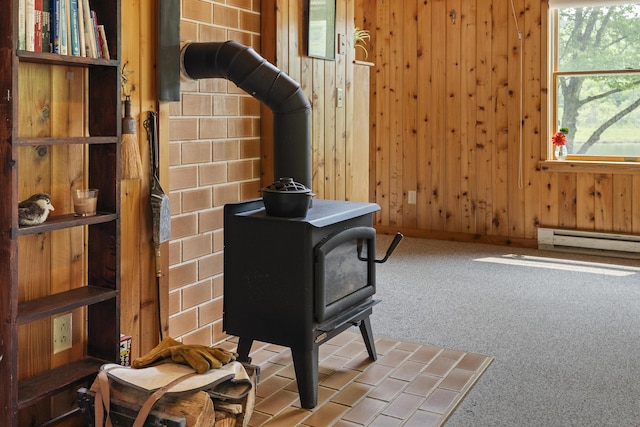 67 Day Mountain Rd, Temple, ME 04984 - detailed view of a wood stove, carpet floors, baseboard heating, and wood walls