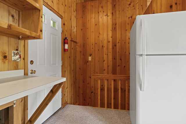 67 Day Mountain Rd, Temple, ME 04984 - interior space featuring freestanding refrigerator, carpet, and wood walls