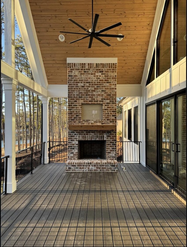 80 Indian Rivers Dr, Eliot, ME 03903 - wooden deck with an outdoor brick fireplace and ceiling fan