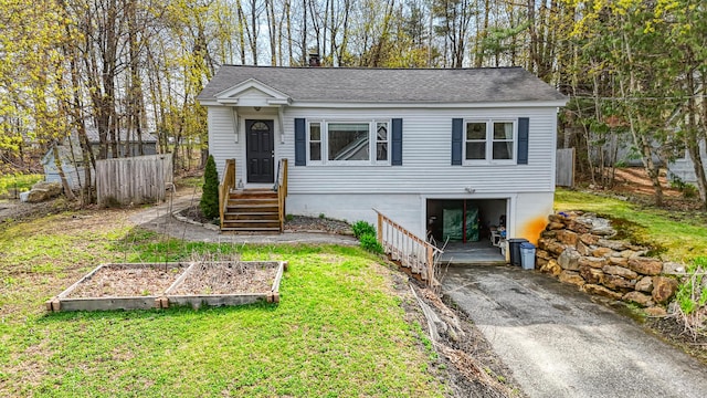 19 Brann Ave, Augusta, ME 04330 - view of front facade featuring concrete driveway, a garden, an attached garage, and roof with shingles