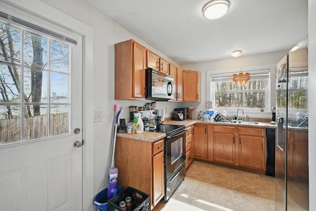 19 Brann Ave, Augusta, ME 04330 - kitchen featuring black appliances, a sink, healthy amount of natural light, and light countertops