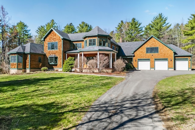 1026 Essex St, Bangor, ME 04401 - shingle-style home with a front lawn, asphalt driveway, and a garage