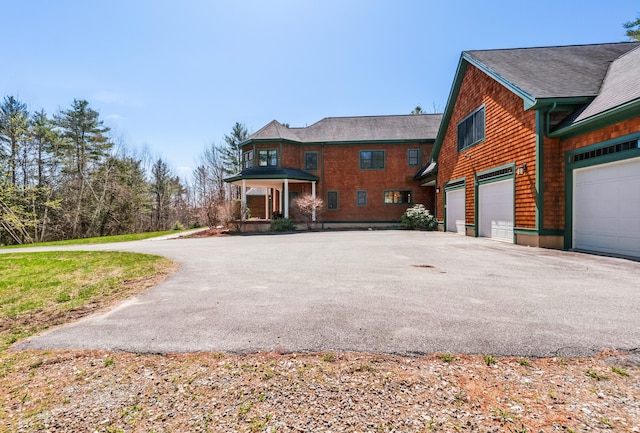 1026 Essex St, Bangor, ME 04401 - view of front of home featuring asphalt driveway and an attached garage