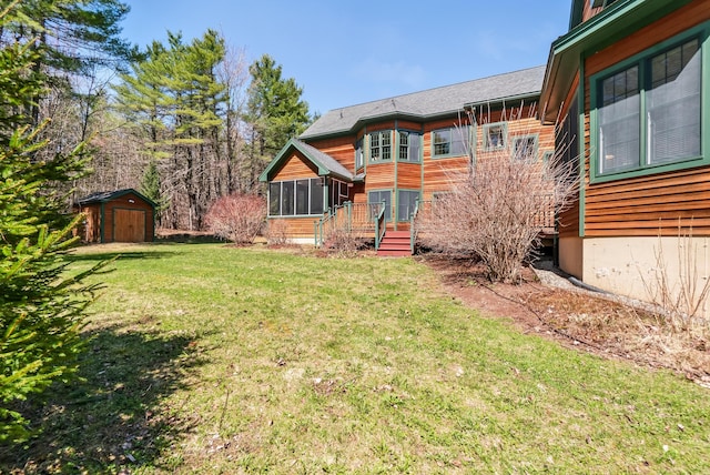 1026 Essex St, Bangor, ME 04401 - view of green lawn with a sunroom, a shed, and an outdoor structure