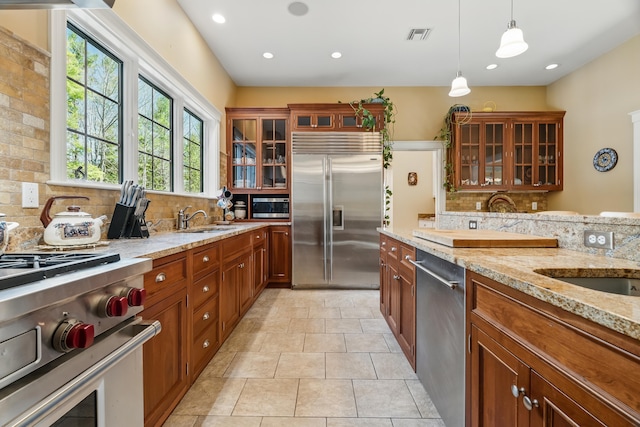 1026 Essex St, Bangor, ME 04401 - kitchen with built in appliances, decorative backsplash, light stone countertops, and recessed lighting