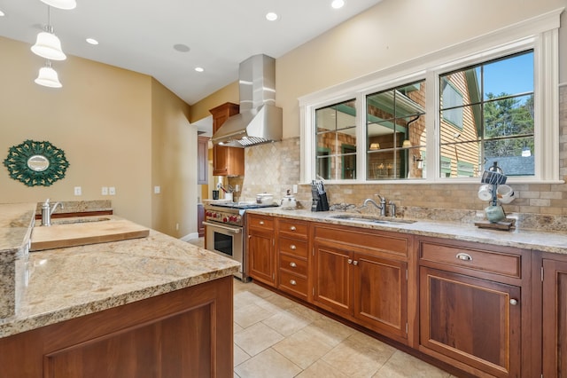 1026 Essex St, Bangor, ME 04401 - kitchen featuring a sink, wall chimney exhaust hood, stainless steel range, brown cabinetry, and recessed lighting
