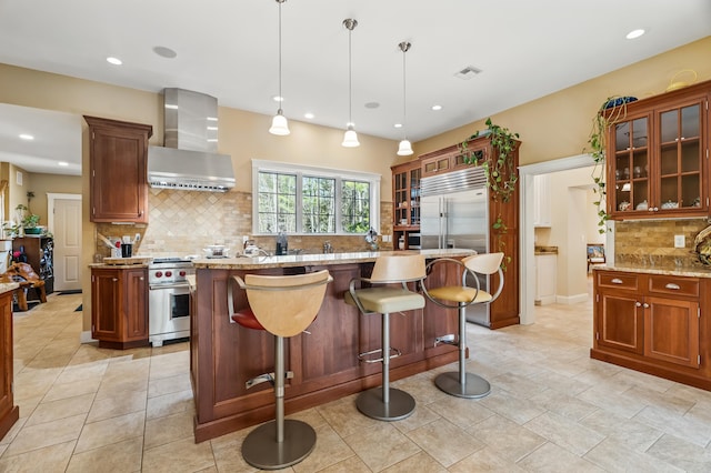 1026 Essex St, Bangor, ME 04401 - kitchen with wall chimney exhaust hood, backsplash, a center island, recessed lighting, and light stone counters