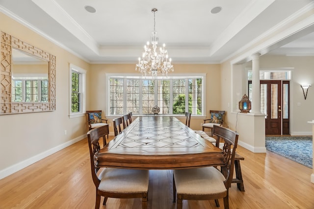 1026 Essex St, Bangor, ME 04401 - dining area with light wood finished floors, baseboards, a chandelier, a tray ceiling, and ornamental molding