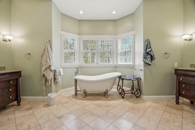 1026 Essex St, Bangor, ME 04401 - full bath featuring vanity, healthy amount of natural light, a freestanding tub, and baseboards