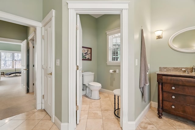 1026 Essex St, Bangor, ME 04401 - bathroom with tile patterned floors, toilet, vanity, and baseboards