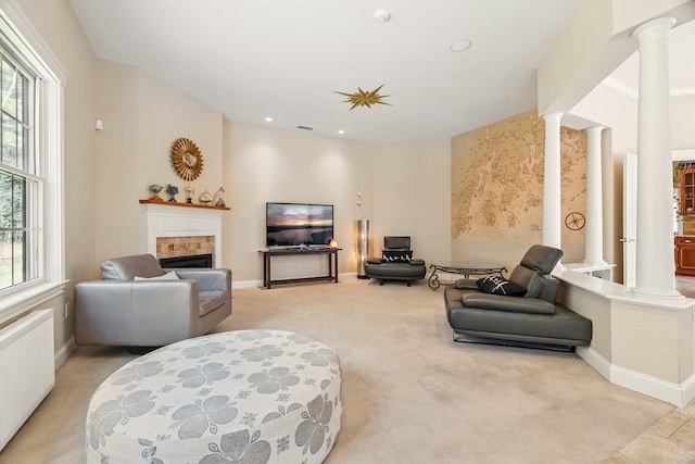 1026 Essex St, Bangor, ME 04401 - living area with ornate columns, radiator heating unit, a fireplace, plenty of natural light, and recessed lighting
