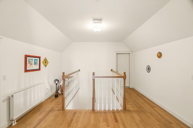 1026 Essex St, Bangor, ME 04401 - additional living space featuring radiator, wood finished floors, vaulted ceiling, and baseboards