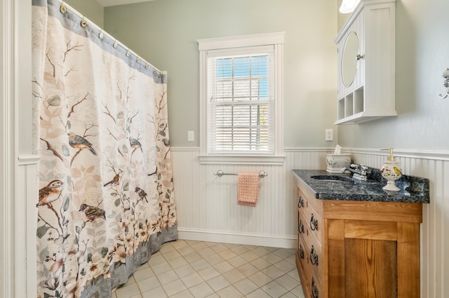 1026 Essex St, Bangor, ME 04401 - full bathroom featuring a wainscoted wall, tile patterned flooring, vanity, and curtained shower