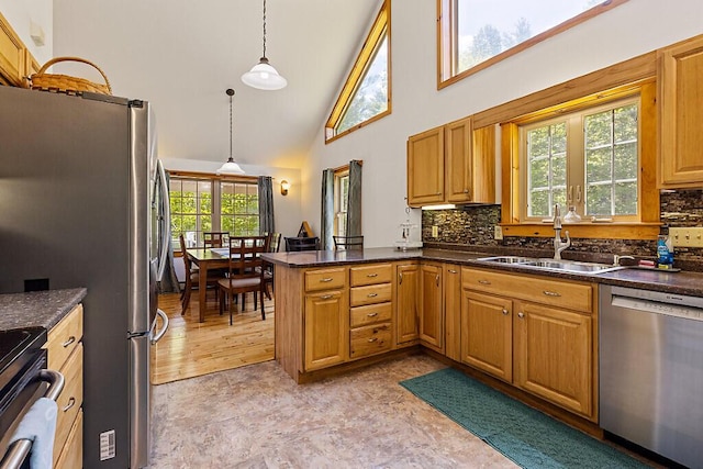 52 Casey Rd, Windsor, ME 04363 - kitchen featuring appliances with stainless steel finishes, a sink, a peninsula, backsplash, and high vaulted ceiling