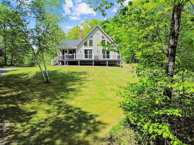 52 Casey Rd, Windsor, ME 04363 - rear view of property featuring a chimney, a lawn, and a deck