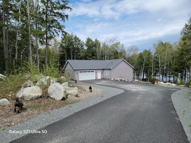 313 Nevells Way, Ellsworth, ME 04605 - view of side of home featuring asphalt driveway and an attached garage