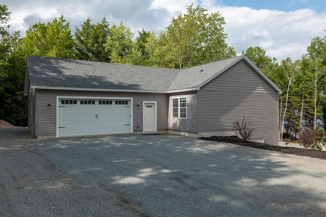 313 Nevells Way, Ellsworth, ME 04605 - view of side of home with an attached garage, asphalt driveway, and a shingled roof
