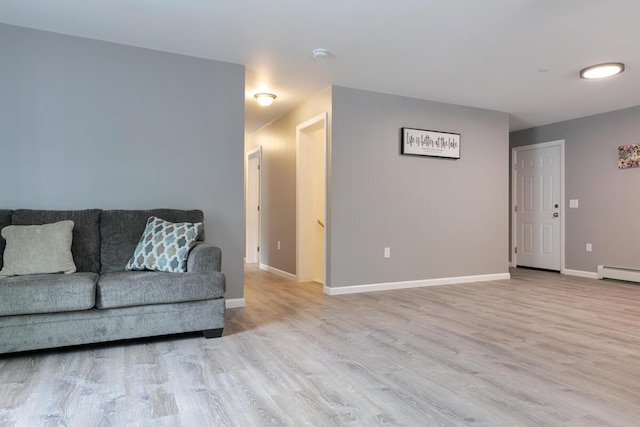 313 Nevells Way, Ellsworth, ME 04605 - living area with wood finished floors, baseboards, and baseboard heating