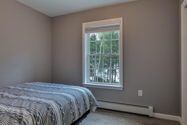 313 Nevells Way, Ellsworth, ME 04605 - bedroom featuring a baseboard radiator, wood finished floors, and baseboards