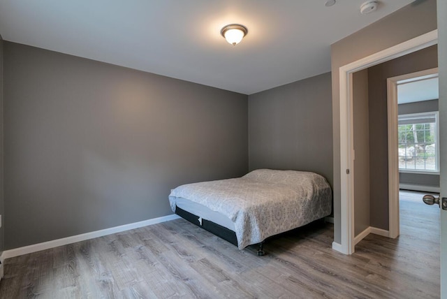 313 Nevells Way, Ellsworth, ME 04605 - bedroom with a baseboard heating unit, wood finished floors, and baseboards