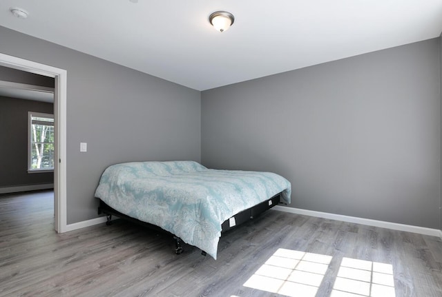 313 Nevells Way, Ellsworth, ME 04605 - bedroom with a baseboard radiator, wood finished floors, and baseboards