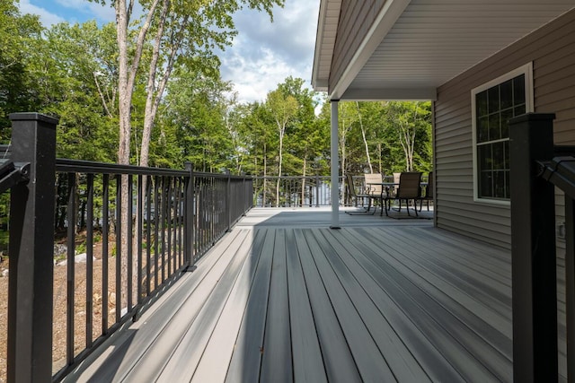 313 Nevells Way, Ellsworth, ME 04605 - wooden deck featuring outdoor dining area and view of wooded area
