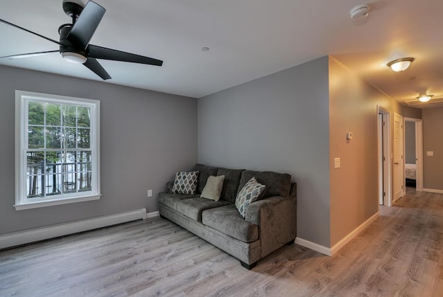 313 Nevells Way, Ellsworth, ME 04605 - living room featuring a ceiling fan, wood finished floors, a baseboard radiator, and baseboards