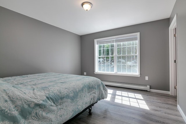 313 Nevells Way, Ellsworth, ME 04605 - bedroom featuring a baseboard heating unit, wood finished floors, and baseboards