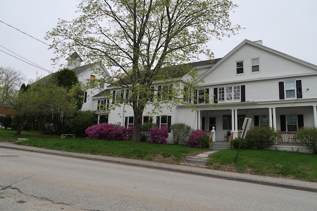 11 Green St, Winthrop, ME 04364 - view of front facade with a porch and a front lawn