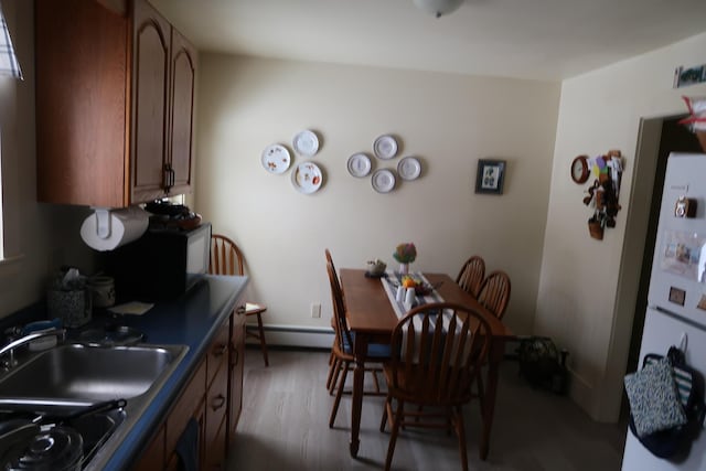 11 Green St, Winthrop, ME 04364 - dining room with a baseboard heating unit and wood finished floors