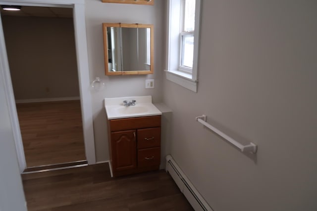 11 Green St, Winthrop, ME 04364 - bathroom featuring wood finished floors, vanity, baseboards, and baseboard heating