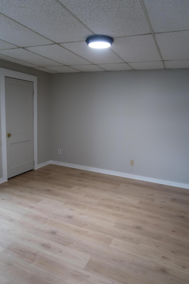 11 Green St, Winthrop, ME 04364 - empty room with baseboards, a drop ceiling, and light wood finished floors