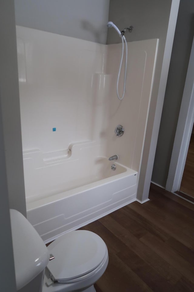 11 Green St, Winthrop, ME 04364 - bathroom featuring toilet, wood finished floors, and shower / washtub combination