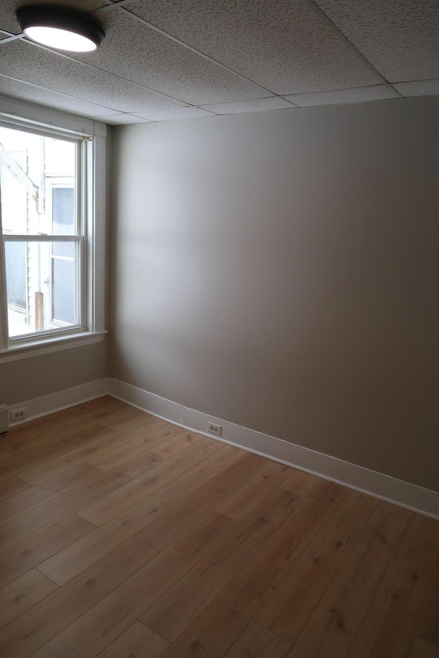 11 Green St, Winthrop, ME 04364 - unfurnished room with a paneled ceiling, baseboards, and wood finished floors