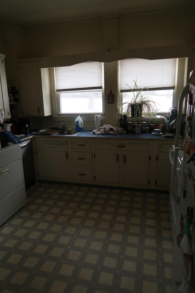 11 Green St, Winthrop, ME 04364 - kitchen with white cabinetry, a sink, and range