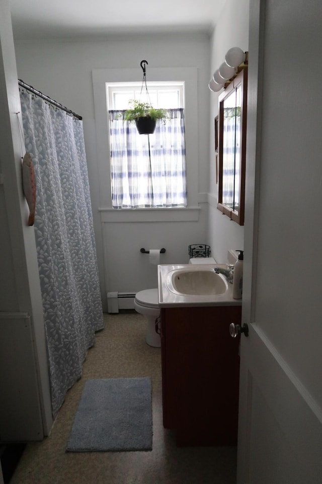 11 Green St, Winthrop, ME 04364 - bathroom featuring a baseboard heating unit, vanity, toilet, and curtained shower