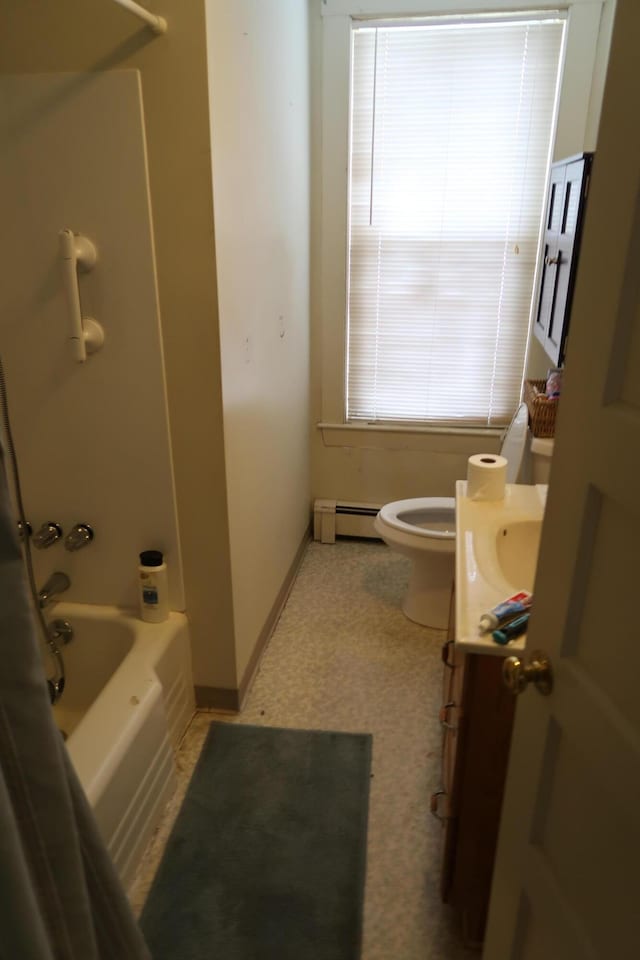 11 Green St, Winthrop, ME 04364 - full bathroom with a baseboard heating unit, toilet, vanity, and washtub / shower combination