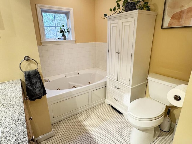 full bath featuring toilet, a whirlpool tub, and tile patterned floors