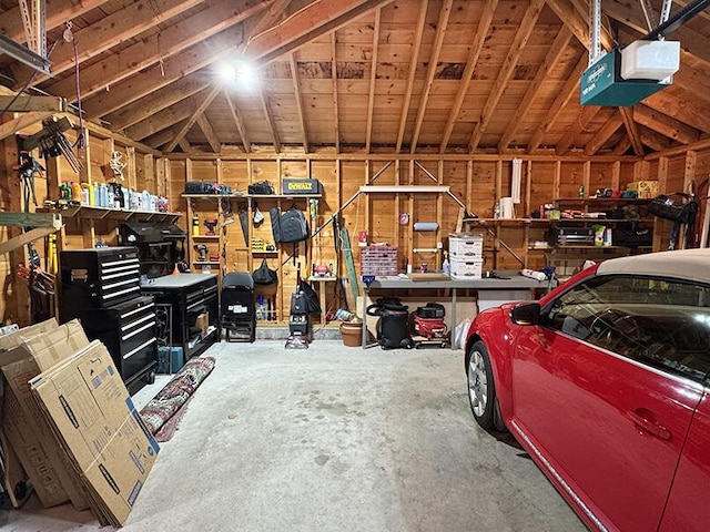 garage with a workshop area and a garage door opener