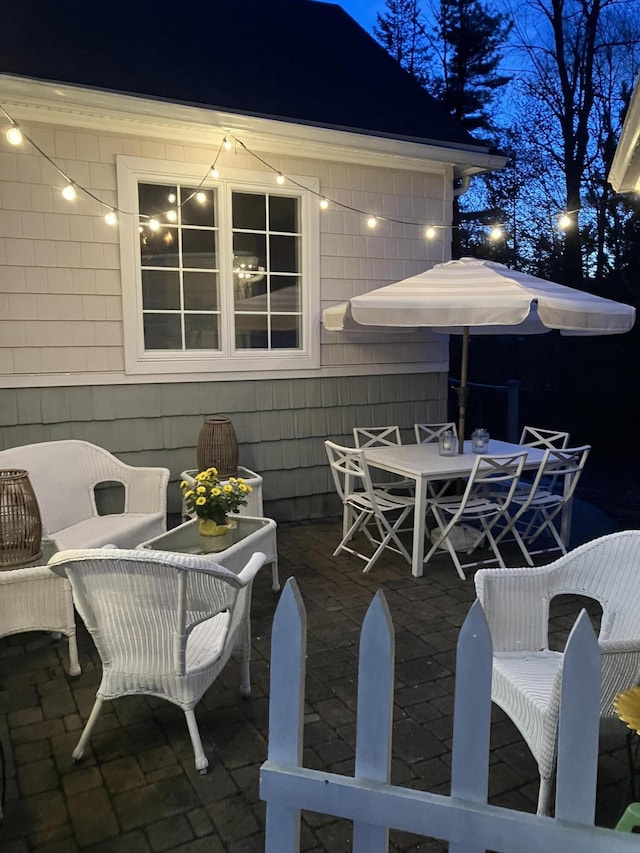 patio at twilight featuring outdoor dining area