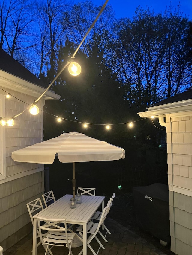 patio at twilight featuring outdoor dining space