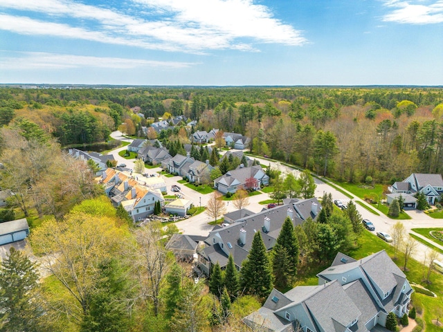 aerial perspective of suburban area featuring a heavily wooded area