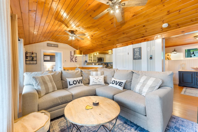 61 Beechwoods Rd, Oxford, ME 04270 - living room with ceiling fan, wood ceiling, vaulted ceiling, wood finished floors, and wooden walls